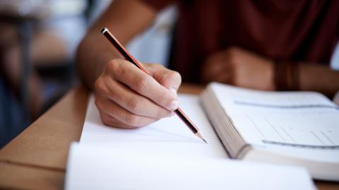 A pupil taking an exam at school