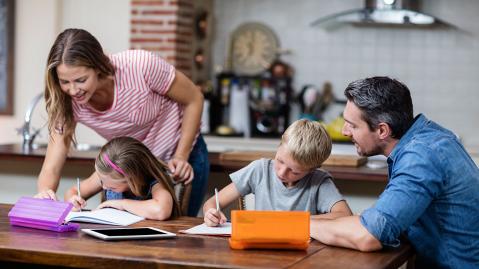A family works together on the children's homework